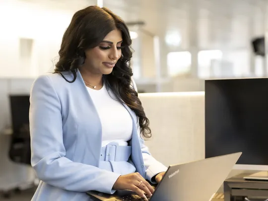 Bosshard & Partner employee working on a laptop.