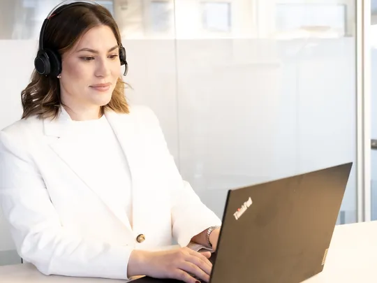 Bosshard & Partner employee working on a laptop.